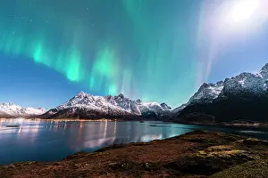 Northern Prints: Moonlight illuminates the northern lights over the mountains and fjord in Norway's Lofoten Islands