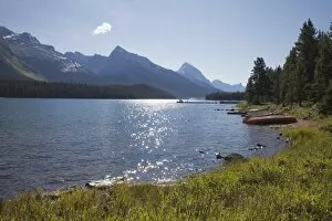 Images Dated 8th August 2011: Morning light on Maligne Lake with canoes on shoreline, Jasper National Park