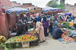 Buying Prints: Moroccan people buying and selling fresh fruit in the fruit market in the old medina