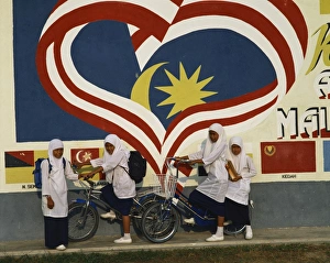Moslem girls on bicycles in Malaysia