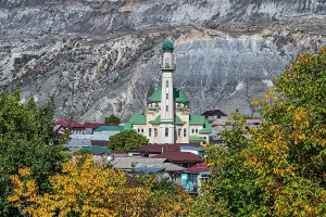 Waterfall Prints: Mosque stands above the Saltinskiy Underground Waterfall surrounded by mountains in Dagestan