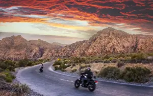Motorcycle Prints: Motocycles driving through The Red Rock Canyon National Recreation Area at sunset