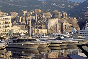 Anchor Prints: Motor cruisers at anchor and highrise buildings above the harbour, La Condamine