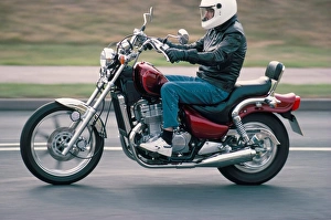 Head Piece Prints: Motorcyclist rides Suzuki twin motorcycle on highway, Dawlish, Devon, England
