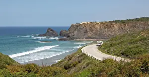 Crashing Waves Prints: Motorhome parked at viewpoint of Atlantic Ocean waves breaking on rocky headland and bay with sandy beach