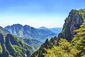 Wonders Prints: Mount Huang offers wide views across rolling hills and distant peaks in Anhui Province during clear weather