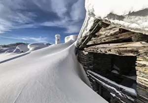 Lombardy Prints: A mountain hut emerging from thick snow after a heavy snowfall in the Alpe Scima
