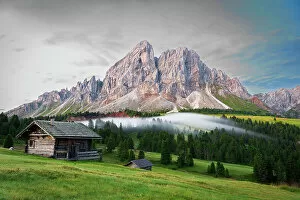 Mountain huts among green woods with fog in the morning, Sass De Putia, Passo delle Erbe, Dolomites, South Tyrol, Italy