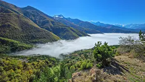 Bright Prints: Mountain landscape in North Ossetia with fog covering the valley on a sunny day