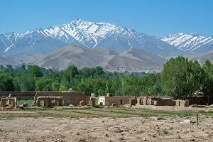 Stones Prints: Mountain scenery near Bamyian shows ancient ruins and snow-capped peaks in Afghanistan during daylight