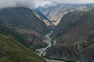 Terrain Prints: Mountain scenery in North Ossetia reveals winding river and rugged terrain along the Caucasus mountains in Russia