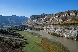 Lush Prints: Mountain scenery with river and cliffs in Dagestan