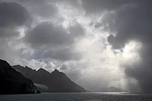 Dramatic Skies Prints: Mountainous coastline near Drygalski Fjord with cloudy skies