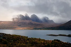 Mountains in the mist facing a lake in the Scottish Highlands, Scotland, United Kingdom