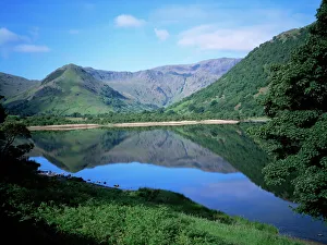Mountains reflected in still water of the lake, Brothers Water, Lake District