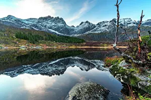 Stillness Prints: Mountains and their reflections in a lake at Nusfjord in Lofoten Islands during early morning light in Norway