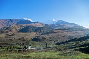 Terrain Prints: Mountains rise above green fields in Verkhny Fiagdon area in North Ossetia, Russia