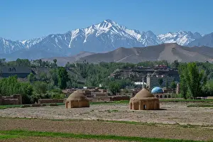 Sites Prints: Mountains rise above the landscape near traditional structures in Afghanistan