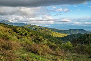 Season Prints: Mountains rise in South Ossetia with green hills and cloudy sky in view during late afternoon sun