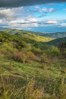 Fresh Prints: Mountains in South Ossetia show green hills and blue skies during daytime