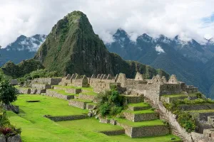 Sights Prints: Mountains surround ancient ruins at Inca site of Machu Picchu in Peru with green terraces