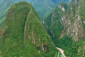 Trekking Prints: Mountains surround a famous Inca site in the region of Peru with lush greenery and steep slopes