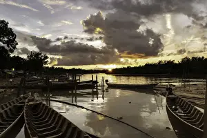 Piers Prints: Mrauk U boat jetty at sunset showing waterlogged canoes in the foreground, Mrauk U