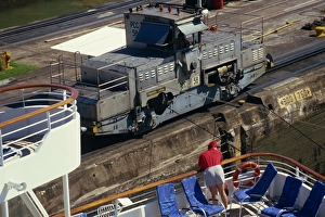 Machinery Prints: A mule guides a ship through the Panama Canal