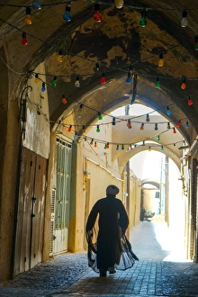 Typically Iranian Prints: Mullah hurrying down typical vaulted alleyway, Yazd, Iran, Middle East
