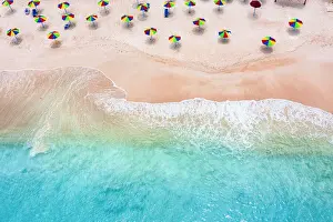 Antigua Prints: Multi colored umbrellas on tropical beach washed by waves of Caribbean Sea