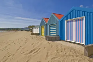 Chalet Prints: Multicoloured beach huts in the dunes on the long sweeping Morfa Gors beach
