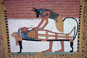 Mural showing the god Anubis leaning over mummy of Ramses II, in the Tomb of Sinjin