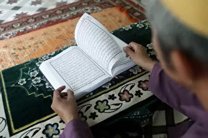 Closeup View Gallery: Muslim man reading an Arabic Holy Quran (Koran), Saigon Central Mosque, Ho Chi Minh City
