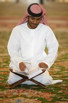 Images Dated 27th October 2009: Muslim man reading the Koran, Sheikh Zayed Grand Mosque, Abu Dhabi, United Arab Emirates