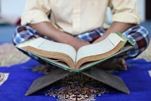 Images Dated 9th March 2010: Muslim man reading the Quran in mosque, Ho Chi Minh City, Vietnam, Indochina