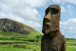 Rituals Prints: Mysterious moai stands strong on Easter Island with volcanic hill in the background under a cloudy sky