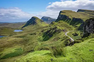 Trotternish Prints: Narrow road winds through rugged hills at Trotternish escarpment on the Isle of Skye in Scotland during daytime