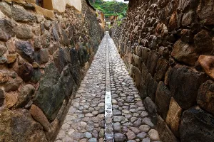 Walkway Prints: Narrow stone street in a historical town with rocky walls and cobblestones in Peru's Sacred Valley