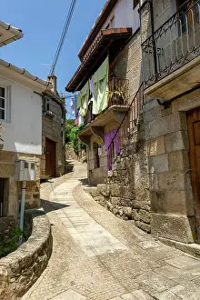 Laundry Prints: Narrow street of historic houses in village of Pazos de Arenteiro