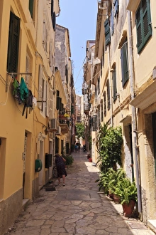 Paving Stone Prints: Narrow street with lady sweeping