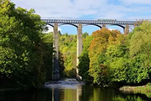 Narrowboat crossing the River Dee in autumn on the Pontcysyllte Aqueduct, built by Thomas Telford