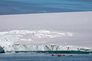 What's New: National Geographic Expeditions, Ponant guests kayaking along an ice cap edge, Larsen Inlet