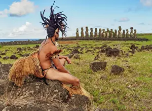 Looking Away Prints: Native Rapa Nui man in tradititional costume and Moais in Ahu Tongariki