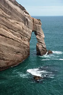 Zealand Prints: Natural sea arch formed by Tasman Sea at coastal cliffs of Cape Farewell on South Island in New Zealand