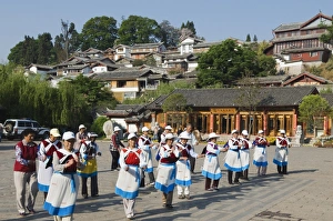 Naxi women dancing in Lijiang Old Town, UNESCO World Heritage Site, Yunnan Province Naxi women dancing in Lijiang Old Town, UNESCO World Heritage Site, Yunnan Province