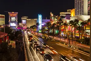 Casino Prints: Neon lights, Las Vegas Strip at night with cars leaving light streaks in front of Caesars