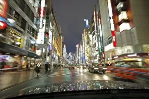Images Dated 13th December 2010: Neon lights on a rainy evening, blurred motion from car, Shinjuku, Tokyo, Japan, Asia
