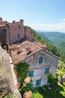 Roofs Prints: Nestled buildings overlooking wooded hills in Saint-Cezaire-sur-Siagne in the Alpes-Maritimes department of France