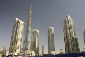 New high rise buildings inland from Jumeirah area, Burj Dubai, worlds tallest building under construction in background