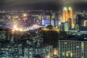 North Korean Prints: New modern buildings in the centre of Pyongyang colourfully illuminated at night